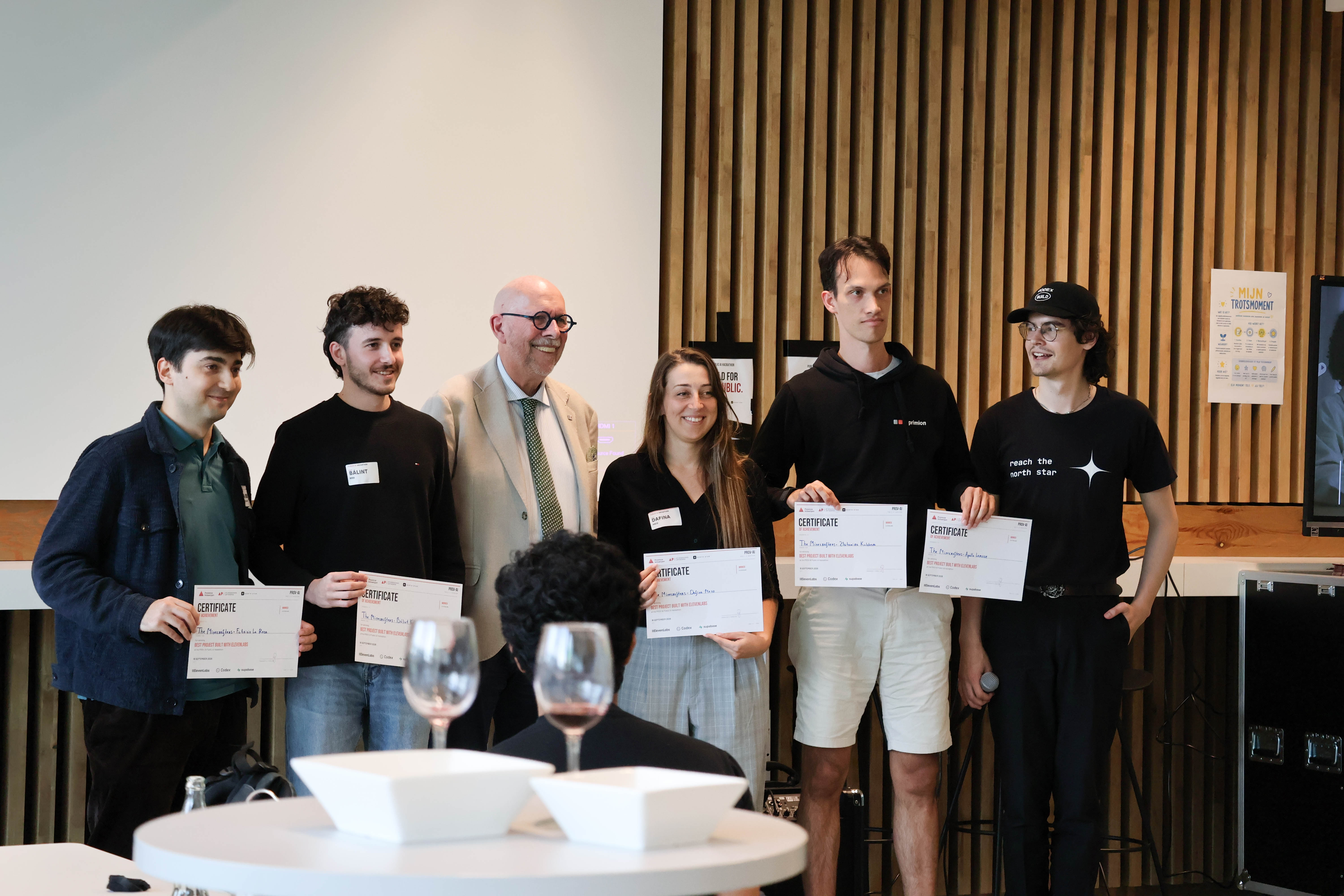 Hackathon winners stand with their certificates and judges.